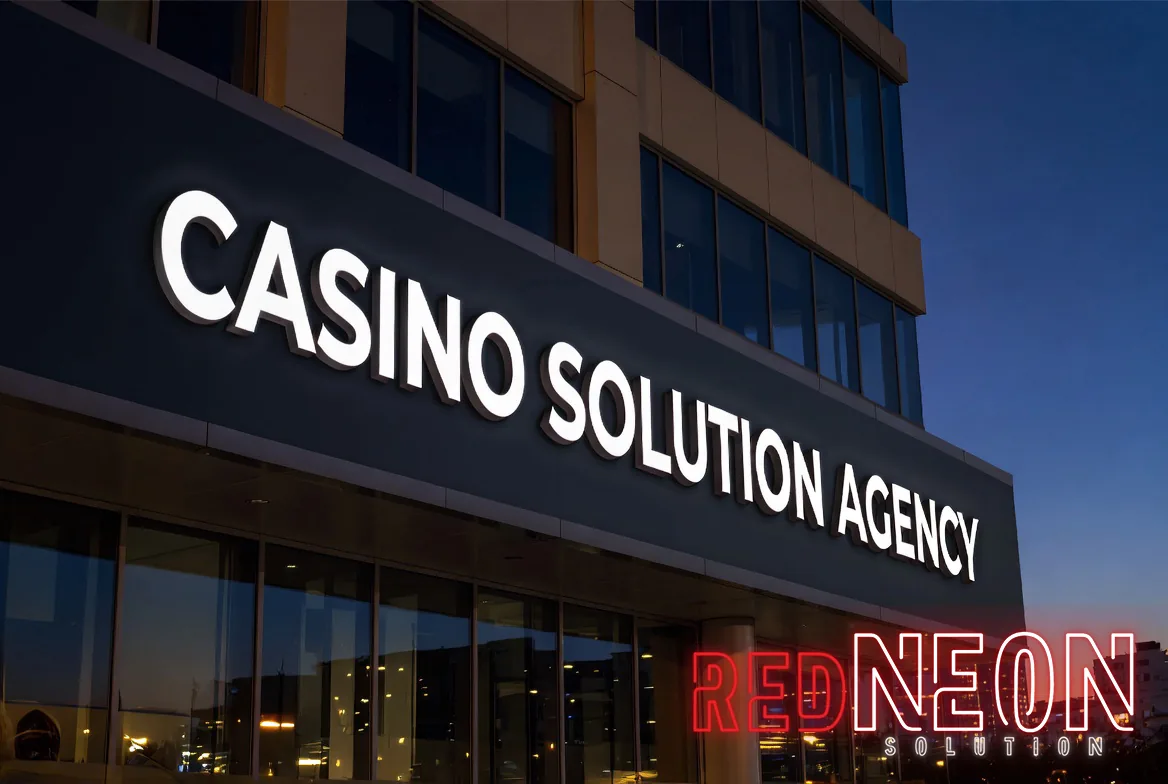 저녁 하늘을 배경으로 CASINO SOLUTION AGENCY 간판이 있는 사옥 외관 사진